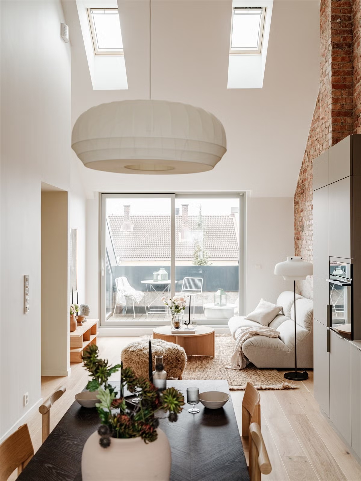 Living Under the Sky attic apartment in Oslo with skylights and double-height living space, designed by IK-architects
